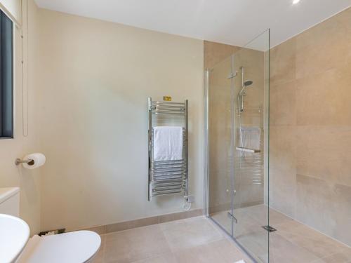 a bathroom with a shower with a glass door at Partridge in East Ilsley