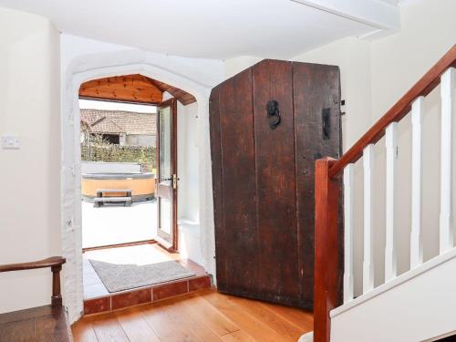 an open hallway with a large wooden door at Nempnett Farmhouse in Bristol