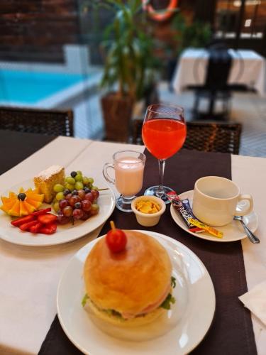 a table with plates of food and drinks on it at Santa María Express in Santiago