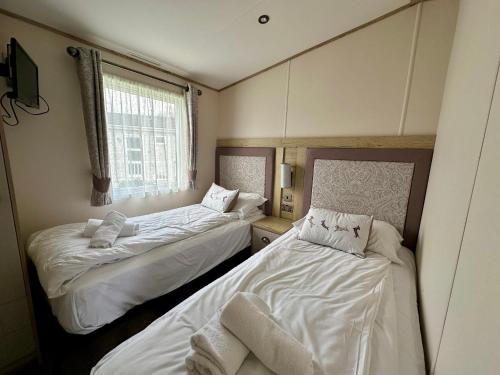 南塞爾尼的住宿－Paws Lodge, Hot Tub, Pet Friendly，客房设有两张床和窗户。