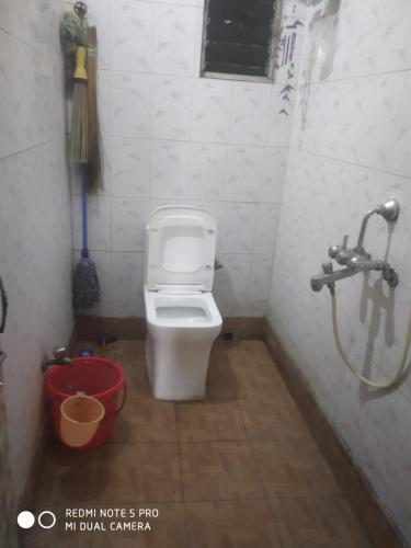 a bathroom with a toilet and a shower at Gouri Bhawan in Kolkata