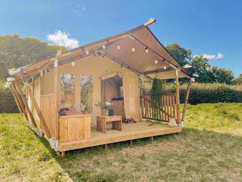 a gazebo with a deck in a field at Càmping Castell Montgrí **** in L'Estartit