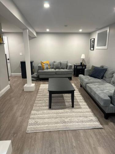 a living room with two couches and a coffee table at Private Basement Suite in Halifax in Halifax