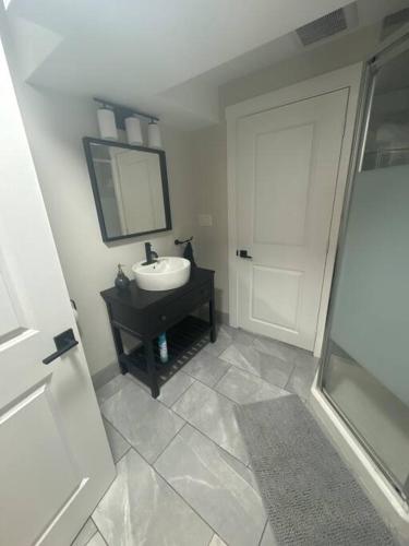 a bathroom with a sink and a mirror at Private Basement Suite in Halifax in Halifax