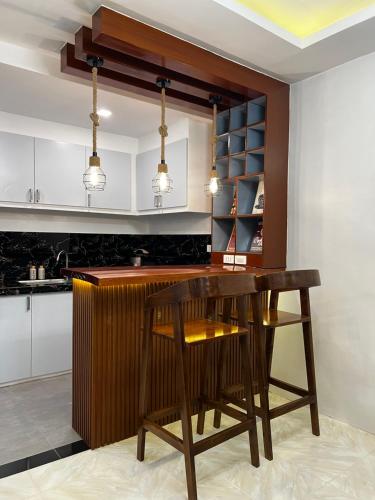 a kitchen with a wooden table and a counter at KENNA'S NOOK in Butuan