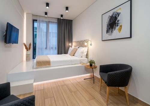 a bedroom with a bed and a table and chairs at Luxury 101 Studio apartment in central Athens in Athens
