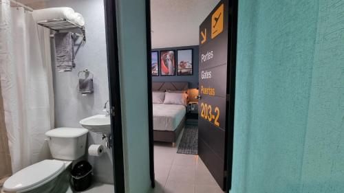 a bathroom with a bed and a toilet and a sink at A 5 Minutos del Aeropuerto Departamento Temático in Mexico City