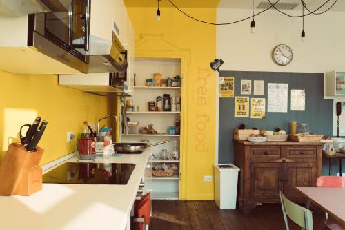 a kitchen with yellow walls and a counter top at Ostello Bello Lake Como in Como