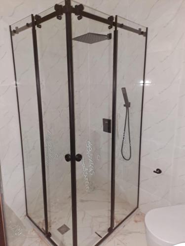 a shower with a glass door in a bathroom at Almare Batumi in Batumi