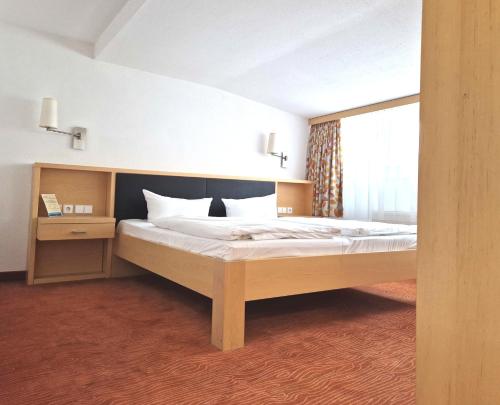 a bedroom with a large bed in a room at Hotel Lindenhof Bad Schandau in Bad Schandau