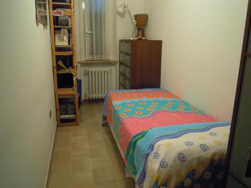 a bedroom with a bed and a dresser in a room at Le Fornaci in Castelfidardo