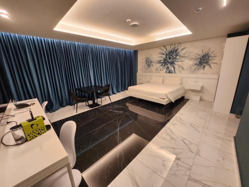 a room with a bed and a table and chairs at DEMSI Palace Hotel & Restaurant in Foggia