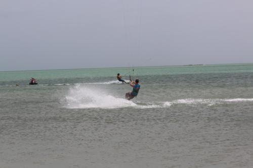 two people are water skiing in the ocean at Masirah Beach camp in Al Qārin