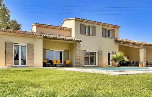une grande maison avec une pelouse devant dans l'établissement La Villa Du Mont Ventoux, à Uchaux