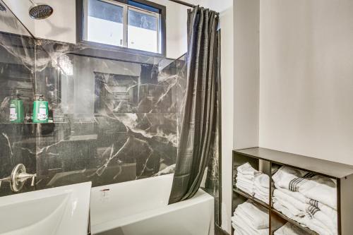 a bathroom with a sink and a shower at New Orleans Duplex 2 Mi to Bourbon Street! in New Orleans