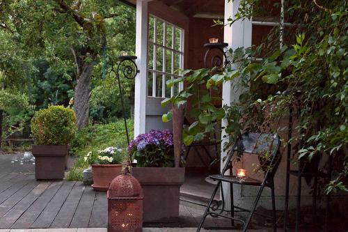 a porch of a house with a fire hydrant and flowers at Exklusives Landhaus in den Bergen in Arzl im Pitztal