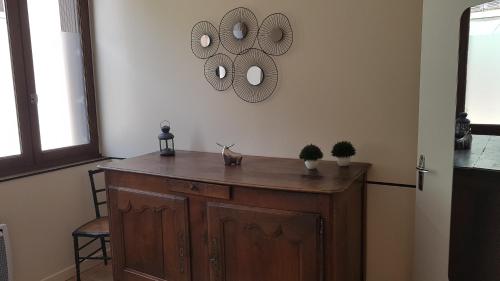 a room with a wooden cabinet and a mirror on the wall at Gîte Valentine in Aubin