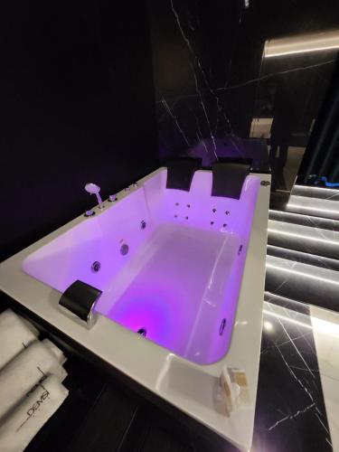 a bath tub with purple lighting in a bathroom at DEMSI Palace Hotel & Restaurant in Foggia