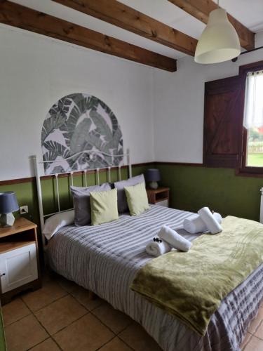 ein Schlafzimmer mit einem Bett mit zwei ausgestopften Tieren darauf in der Unterkunft Apartamentos Rurales El Buxu in Soto de Cangas