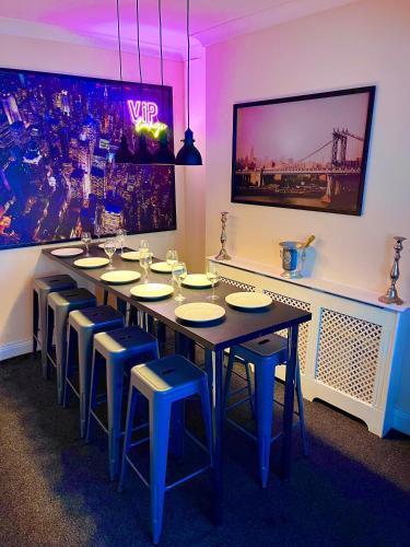 a dining room with a long table and chairs at Tyne Bridge View in Newcastle upon Tyne