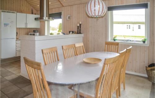 a kitchen and dining room with a table and chairs at Hugoline in Hovborg