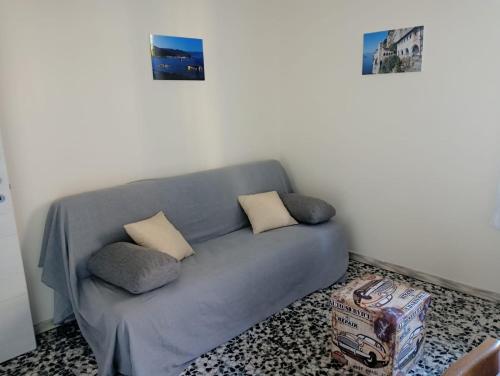 a gray couch in a room with two pillows at Casa Margherita - bike friendly in Verbania