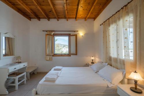 una camera con letto, lavandino e finestra di Maria's Village Two Bedroom House 1 ad Aliki