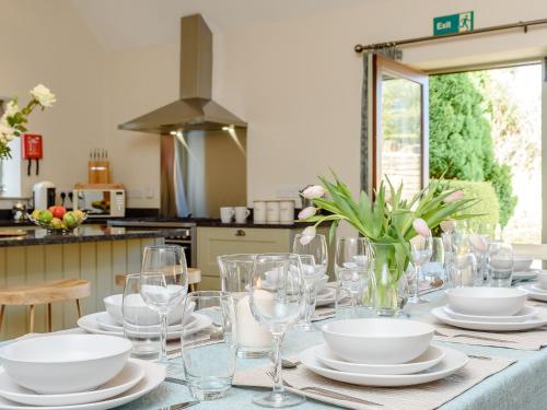 a table with plates and glasses on a table at Tull in Dyrham