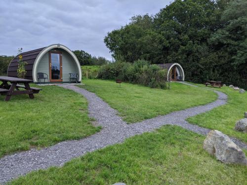 a garden with a tent and a gravel path at Killynick Glamping Oiney Fishing County Fermanagh in Enniskillen