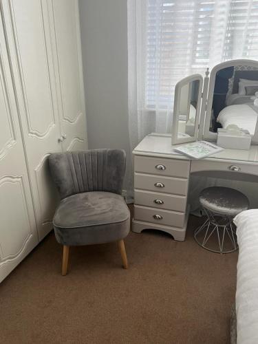 a bedroom with a desk with a chair and a mirror at Fair Green B&B in Ballygawley
