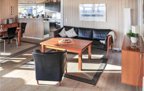 a living room with a couch and a table at Holiday Home Bellevue Iii in Skovby
