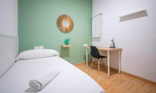 Schlafzimmer mit einem Bett und einem Schreibtisch mit einem Spiegel in der Unterkunft TarracoHomes-TH08 Apartamento con patio privado en el centro de Tarragona in Tarragona