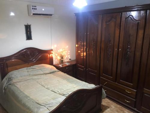 a bedroom with a large bed and wooden cabinets at THURIN IMO in Saint-Louis