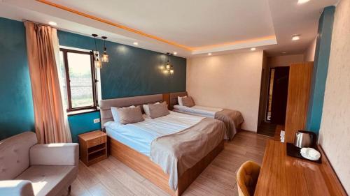 a bedroom with two beds and a table in it at Old Tatev Guesthouse in Tatʼev