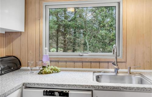 a kitchen counter with a sink and a window at Holiday Home Blomstervangen Oksbøl Iii in Oksbøl