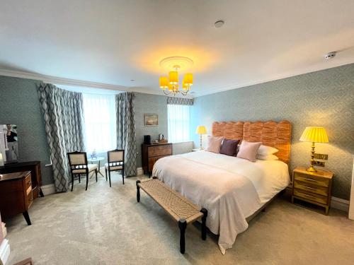 a bedroom with a large bed and a table and chairs at Old Town House by Ezestays, IN THE HEART OF THE OLD TOWN MARGATE in Margate