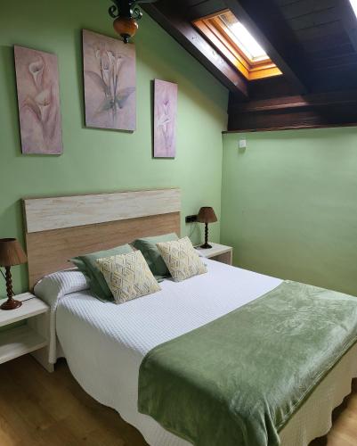 a bedroom with a large bed with green walls at Casa Rural Larraldea in Elizondo