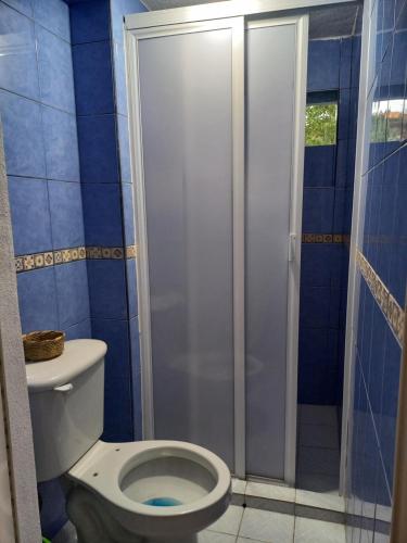 a bathroom with a toilet and a shower at Hotel Paraíso de San Sebastián Jalisco in San Sebastián del Oeste