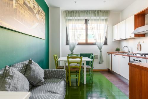 a kitchen and living room with a couch and a table at Levante96 in Bologna
