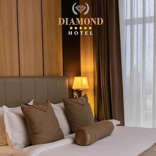 a hotel room with a bed with a sign on the wall at Hotel Diamond Prishtina in Pristina