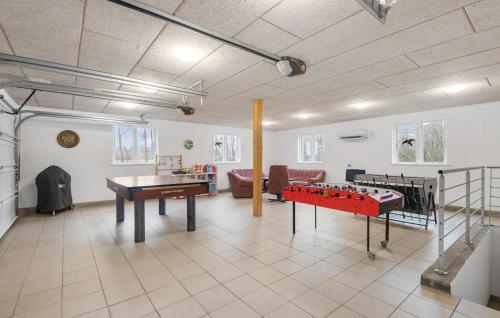 a living room with a ping pong table in it at Five-Bedroom Holiday Home In Kibak in Ørbæk