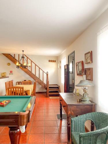 a living room with a pool table and a staircase at Casa do Porto Formoso – Praia dos Moinhos in Porto Formoso