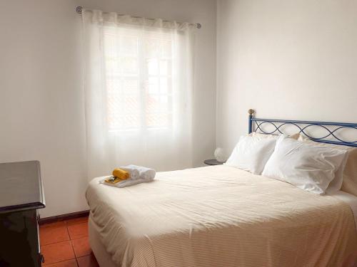 a bedroom with a bed with a stuffed animal on it at WelcomeBuddy - Casa da Praia - Moinhos Beach in Porto Formoso