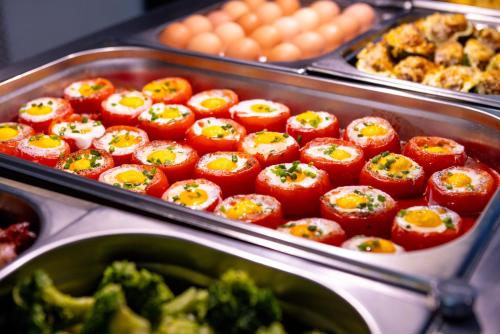 a buffet of food with tomatoes and broccoli at Max Health Resort SPA in Ustronie Morskie