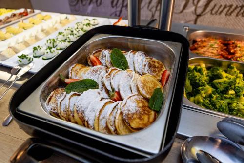 a pan filled with meat and vegetables on a table at Max Health Resort SPA in Ustronie Morskie