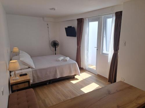a bedroom with a bed and a large window at Venue Studios in Lima