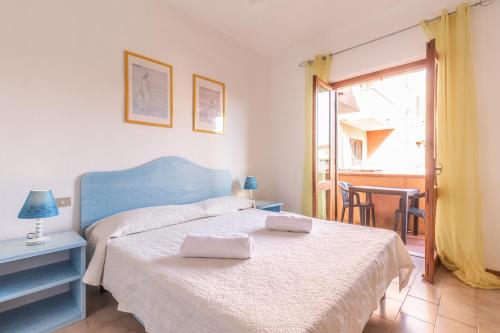 a bedroom with a bed with two towels on it at Baia Turchese Olbia in Olbia