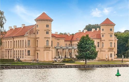 a large castle with a lake in front of it at Beautiful Ship In Neuruppin With Lake View in Neuruppin