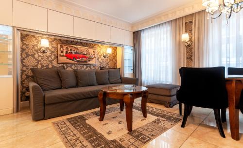a living room with a couch and a table at Luxury Apartments - Wroclaw Old Town - Wrocław Rynek in Wrocław