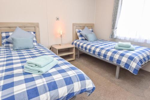 Ένα ή περισσότερα κρεβάτια σε δωμάτιο στο Rowan a welcoming countryside lodge